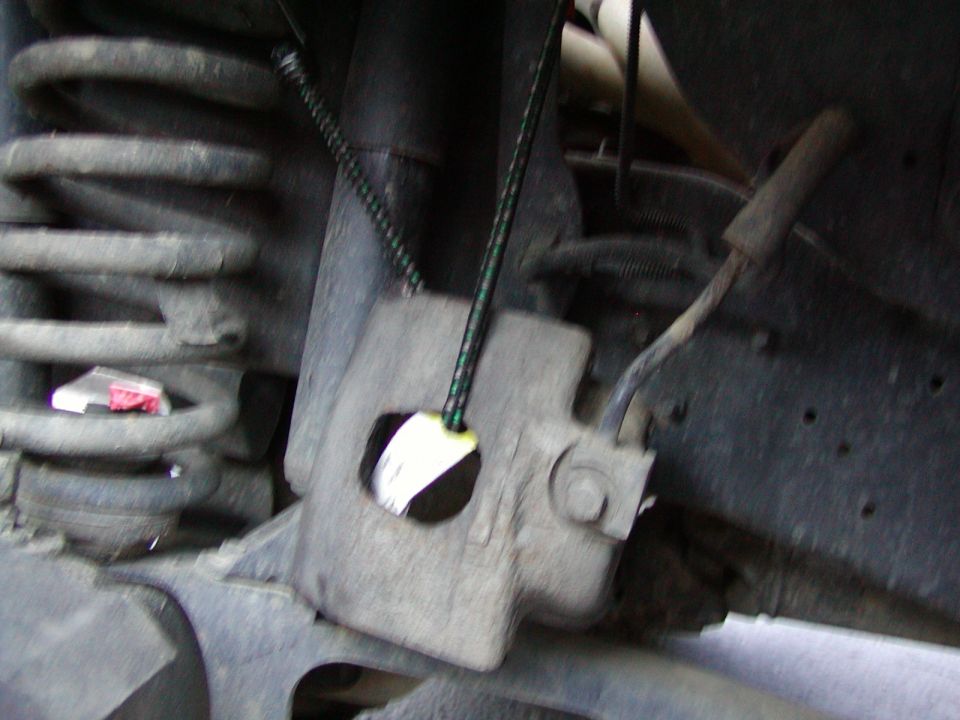 hammer the pins out and hang the caliper out of the way. Toss the pads. Use a bungee to hang the caliper. DONT LET IT HANG BY THE BRAKE LINE