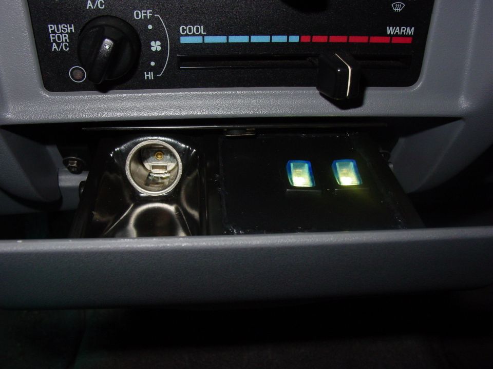Lights controlled by hidden lighted mini switches on a custom pannel in place of the ash tray.