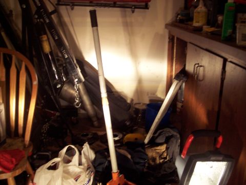 1995 Ford Probe - Cluttered garage interior an engine hoist and storage cabinets.