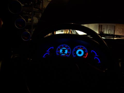 1995 Ford Probe - Interior view of a car's dashboard with illuminated gauges and a steering wheel.