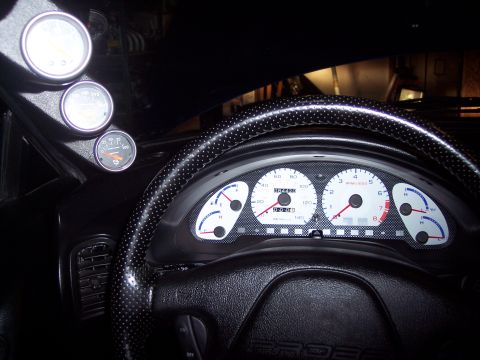 1995 Ford Probe - Dashboard interior with multiple gauges and a steering wheel, showing "PROBE" text on the steering column.