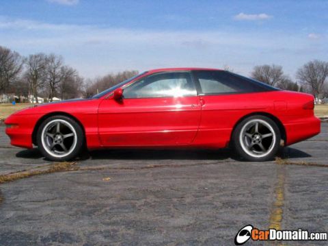 1997 Ford Probe - This 1997 Ford Probe is shown from the side under a partly cloudy sky.