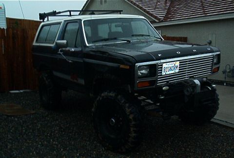 1986 Ford Bronco - This 1986 Ford Bronco features a prominent winch mounted on the front bumper and a roof rack for extra storage.