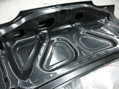1993 Ford Taurus - The underside of a car's trunk lid, showing structural reinforcement and bracing.