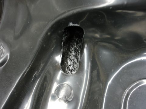 1993 Ford Taurus - A close-up view shows a carbon fiber component fitted into a textured plastic housing.