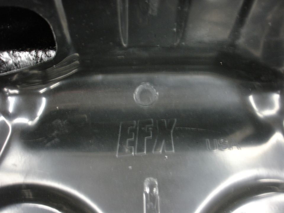 Black plastic automotive part with embossed EFX USA text