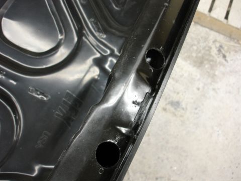 1993 Ford Taurus - Close-up of a black metal part with 'USA' and 'GM' stamped into its surface.