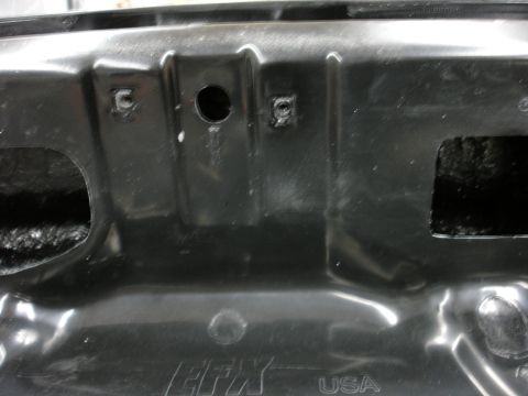 1993 Ford Taurus - Close-up of a stamped metal automotive part, marked 'EFX USA'.