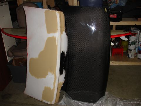 1993 Ford Taurus - A carbon fiber hood is shown next to a white hood that appears to be in the process of being prepped for paint.