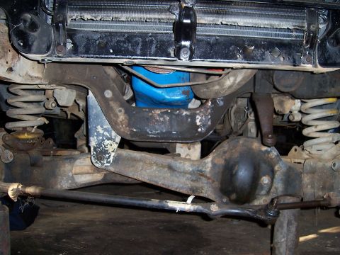1983 Ford Bronco - Close-up view of a vehicle's front axle and suspension system.