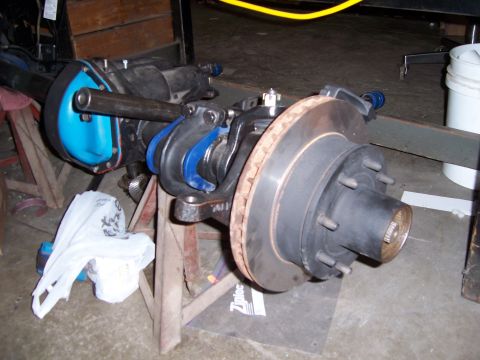 1983 Ford Bronco - A front axle assembly, likely for a truck or SUV, is shown with its disc brake rotor and caliper assembly.