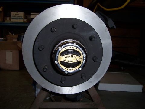 1983 Ford Bronco - Close-up of a Warn locking hub and brake rotor, likely a replacement part.