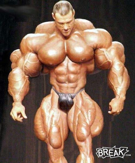 1994 Ford Bronco - Digitally exaggerated joke image of a bodybuilder posing on a dark stage, watermarked BREAK.com. No vehicle or vehicle part is present.