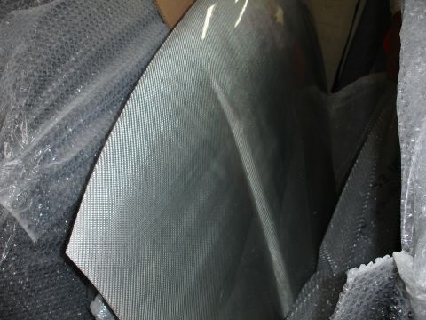 1993 Ford Taurus - A close-up view of a carbon fiber panel, showing its distinctive woven pattern.