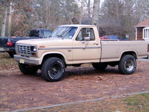 1986 Ford F-250 - This 1986 Ford F-250 pickup truck is seen from a 3/4 front angle, with another truck in the background.