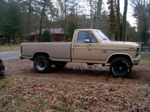 1986 Ford F-250 - Side view of a tan Ford F-250 pickup truck parked outdoors.