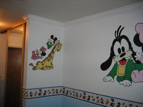 2002 Ford Taurus - A room decorated with Disney character murals, including Mickey, Minnie, and Goofy.