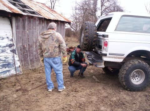 1992 Ford C-150 (Centurion Conversions) - White 1992 Ford C-150 (Centurion Conversions) SUV parked in a muddy area next to a dilapidated barn.