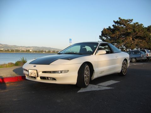 1997 Ford Probe - White 1997 Ford Probe with a black hood stripe parked near a body of water.