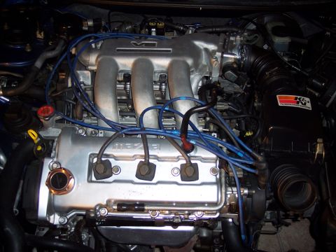 1995 Ford Probe - Engine bay view showing the V6 intake manifold and Mazda branding on the valve cover.