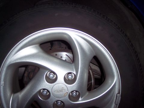 1995 Ford Probe - A close-up view of a car's wheel, revealing the brake system components within.