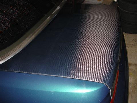 1993 Ford Taurus - The trunk lid of a car has been wrapped in a carbon fiber vinyl decal.