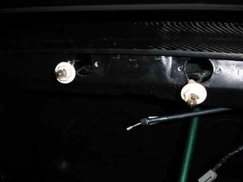 1993 Ford Taurus - Close-up of interior light bulbs and a cable, with a carbon fiber textured panel visible at the top.