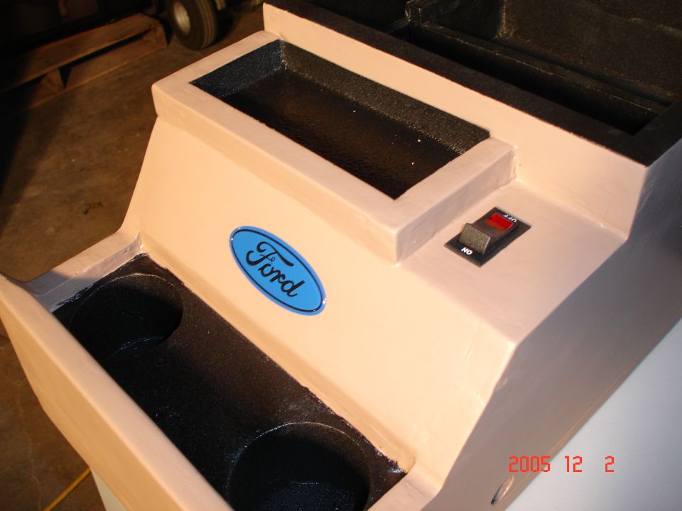 That switch is to my two offroad lights, I wired them under the carpet and through the side of the console. 

The two black cups that came with the stock console fit inside of the two holes, which are just some 3" PVC pipe.