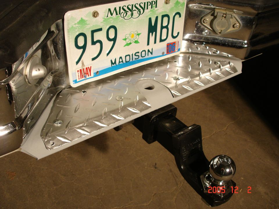 A custom rear bumper step. Made out of diamond plate and cut to fit and painted with a weatherproof aluminum finish.