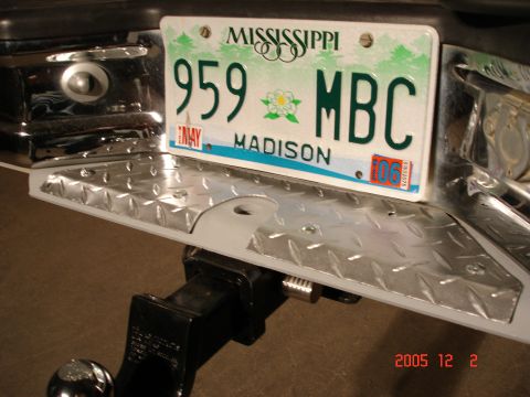 1995 Ford Bronco - This photo shows the rear of a vehicle, including the license plate and a trailer hitch attachment.