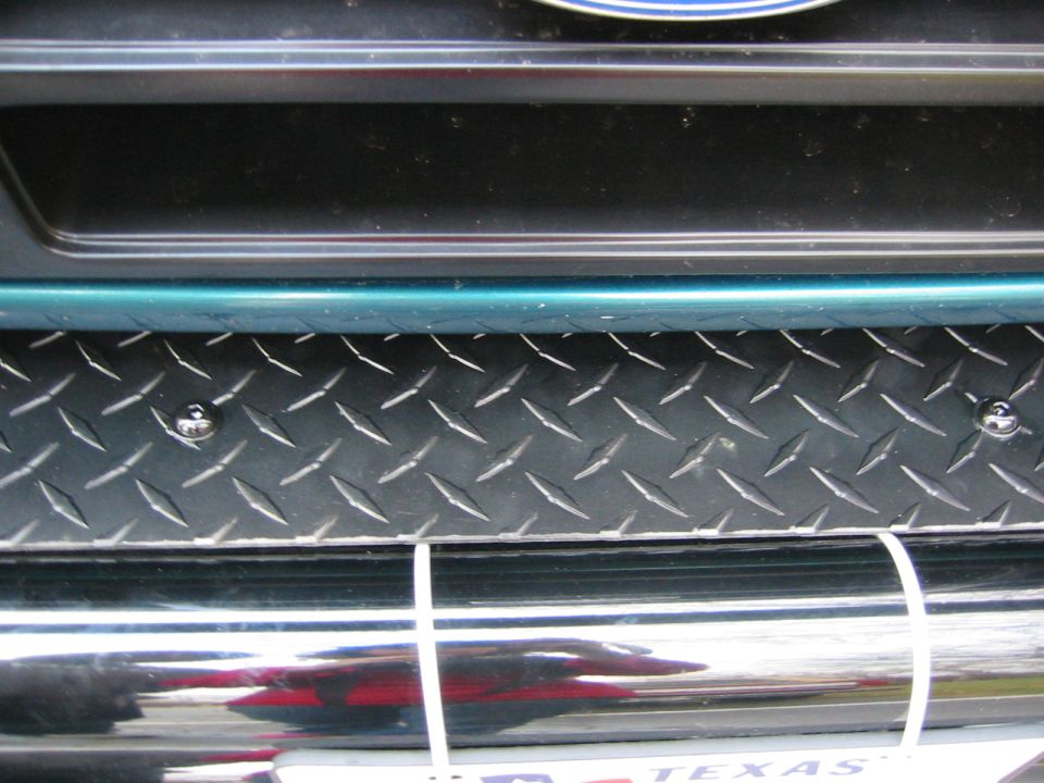 diamond plate insert on a vehicle's front bumper, with chrome accents below