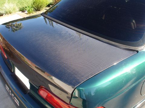 1993 Ford Taurus - A green car features a carbon fiber trunk lid and a "240" badge, suggesting it may not be the 1993 Ford Taurus claimed.