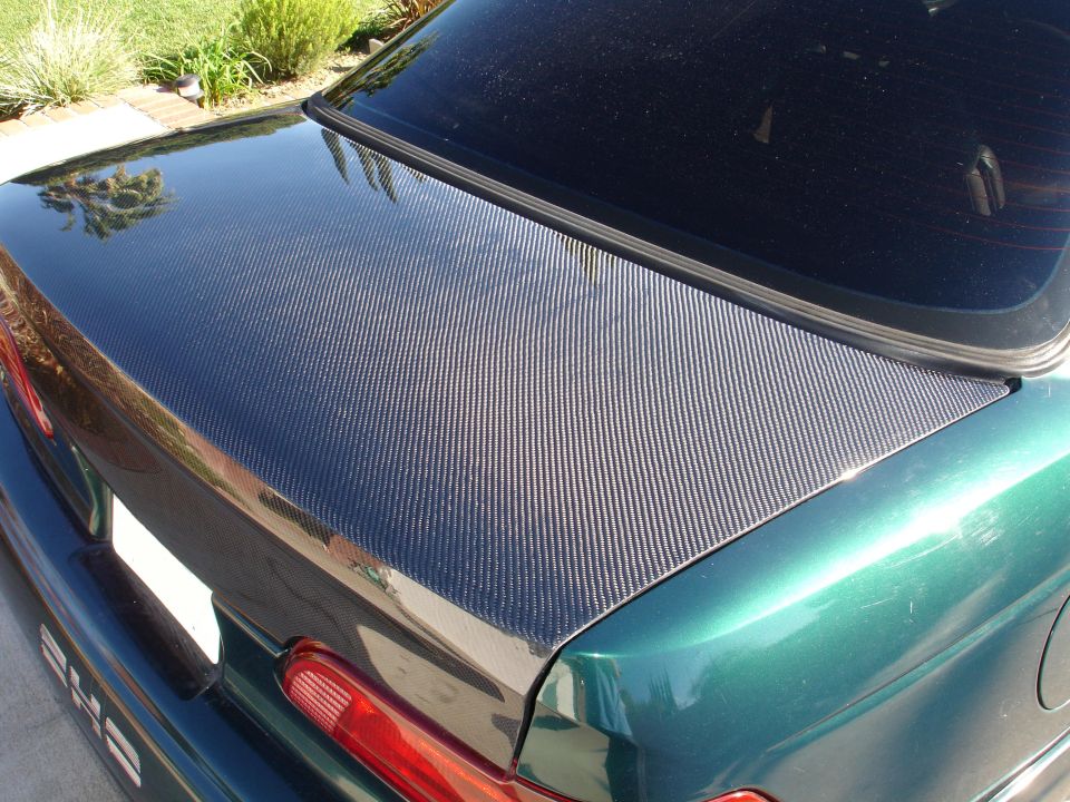 Green car with carbon fiber trunk lid and "240" badge
