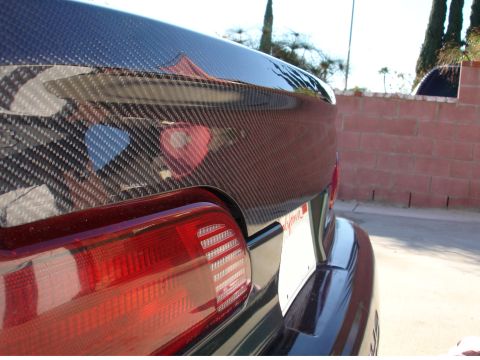 1993 Ford Taurus - Carbon fiber trunk lid and taillight on a car. The license plate is visible.