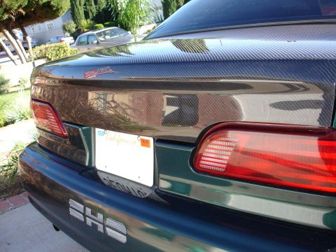 1993 Ford Taurus - Rear view of a 1993 Ford Taurus, a carbon fiber trunk lid accent and a California license plate.