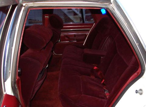 1985 Ford LTD Crown Victoria - The plush maroon velour interior of a 1985 Ford Crown Victoria LTD, comfortable rear seating.