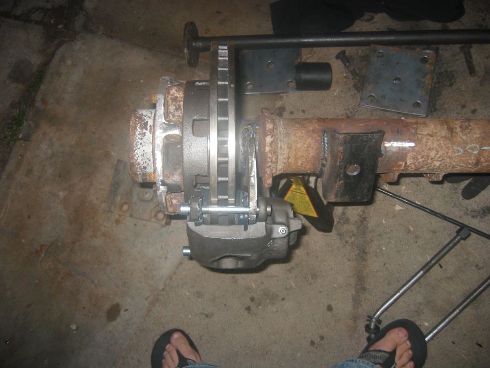 Rear axle assembly with disc brake caliper and rotor