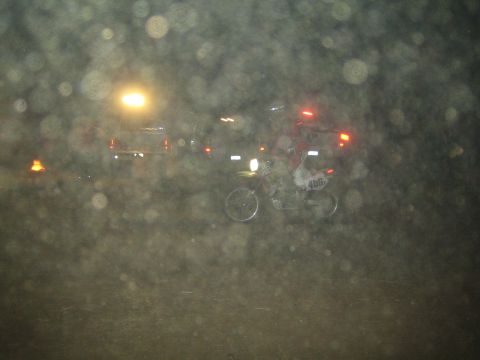 1990 Ford Bronco - distant dirt bike sits on a hazy desert course at night, its headlight glowing through a heavily speckled misty frame.