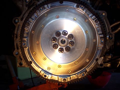 1995 Ford Probe - A close-up view of a vehicle's flywheel and starter ring gear assembly.