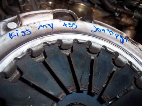 1995 Ford Probe - Clutch pressure plate with handwritten text 'Kiss my ASS Jon 95 pgt' visible.