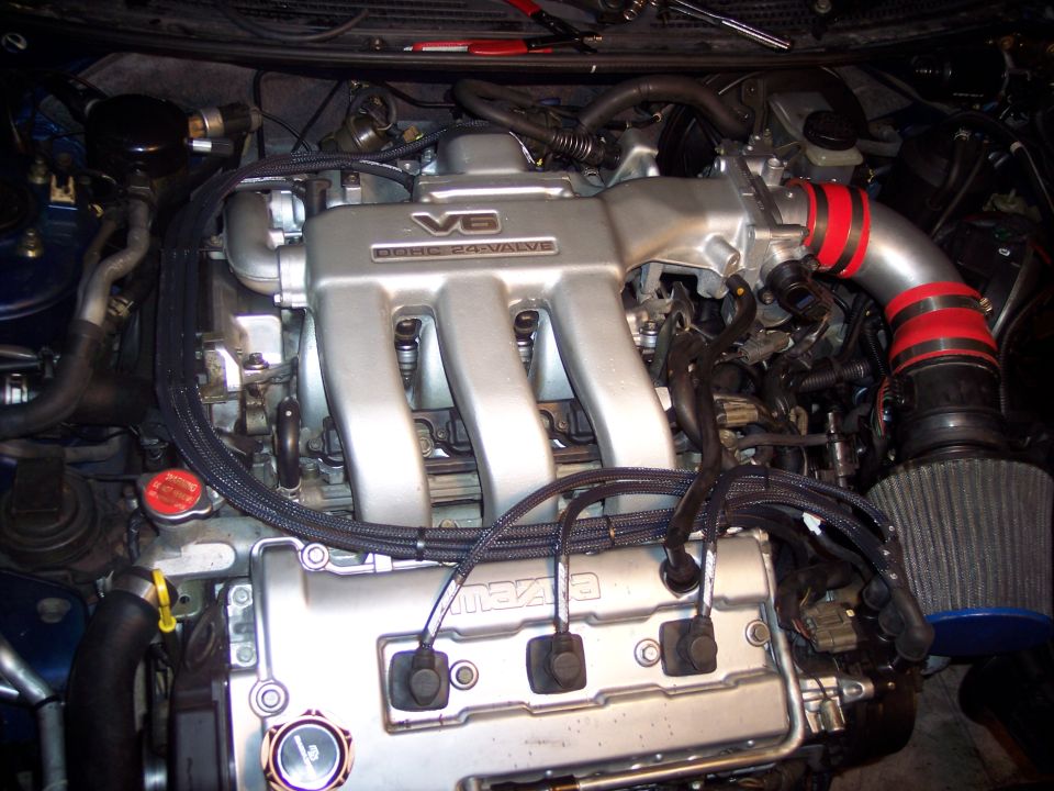 Mazda V6 DOHC 24-valve engine bay with polished cold-air intake and cone filter