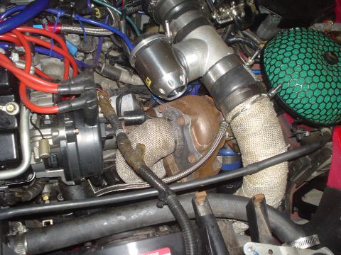 1995 Ford Probe - Close-up view of a modified engine bay showing a turbocharger and associated plumbing.