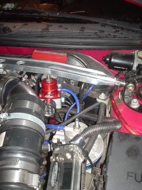 1995 Ford Probe - Custom engine bay modifications include a red fuel pressure regulator and intake piping.