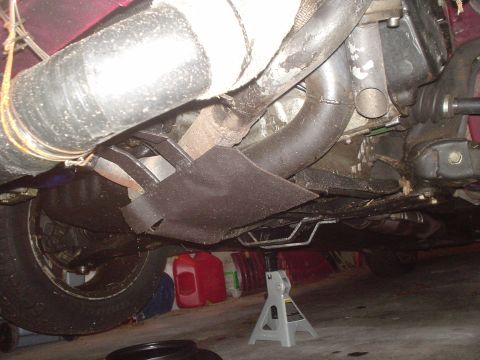 1995 Ford Probe - The underside of a vehicle is shown, with various mechanical components and a tire visible.