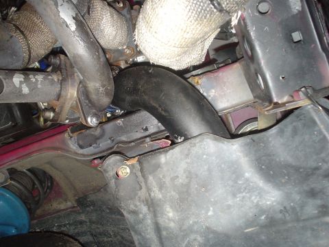 1995 Ford Probe - Close-up view of turbocharger piping and exhaust manifold components within an engine bay.