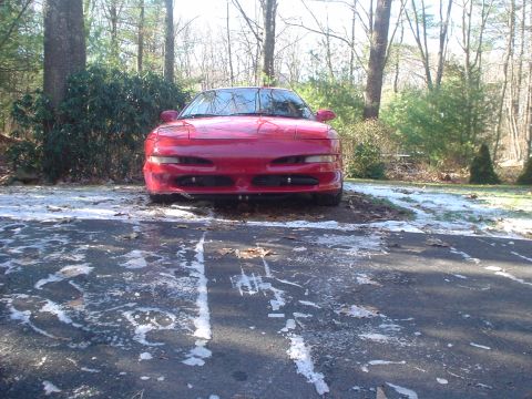 1995 Ford Probe - Front view of a red 1995 Ford Probe in a driveway with snow patches.