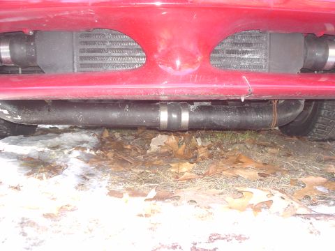 1995 Ford Probe - Close-up of a red vehicle's front end, showing an intercooler and exhaust system.