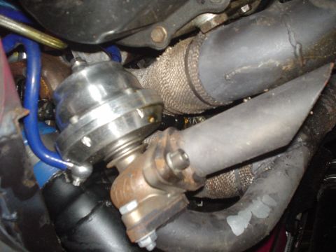 1995 Ford Probe - Turbocharger wastegate and associated piping, likely from a modified vehicle's engine bay.