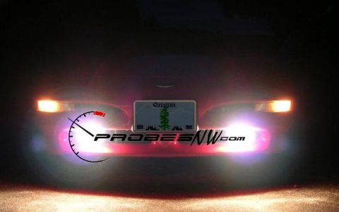 1994 Ford Probe - The rear of a red car is visible at night, an Oregon license plate and the PROBESNW.com logo.