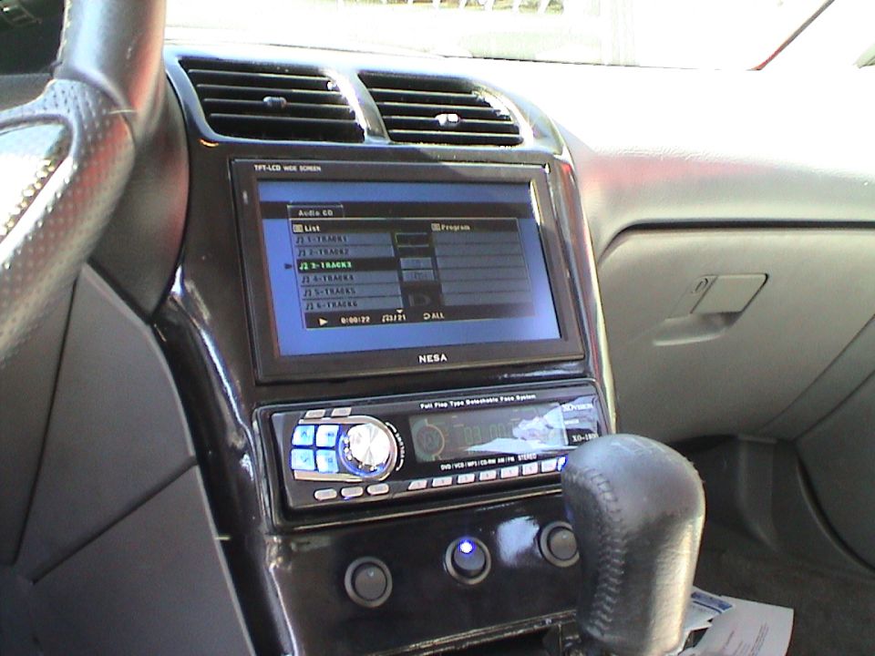 Aftermarket NESA screen and Kenwood stereo installed in a car's dashboard